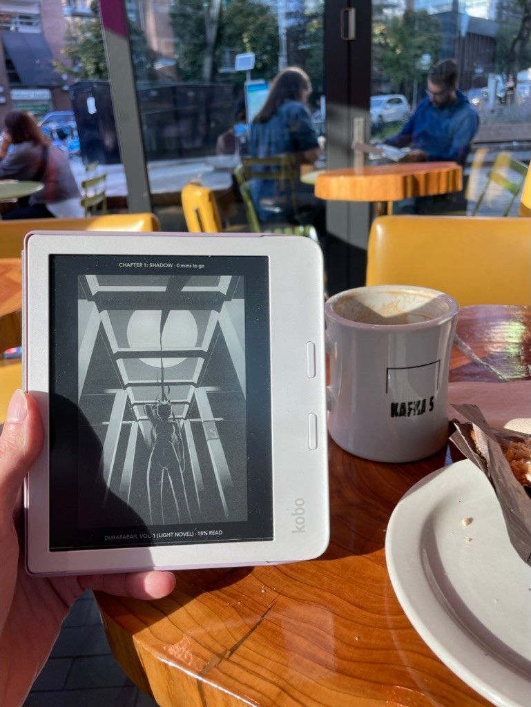 Coffee shop, showing Kobo on light novel page and coffee mug