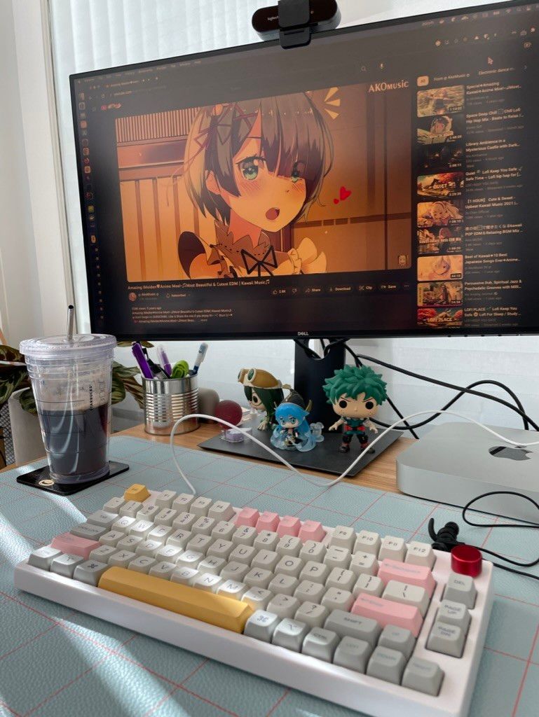 photo showing colorful mechanical keyboard, monitor with Rem from Re:ZERO and Starbucks cup